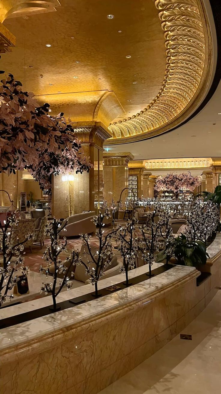 Emirates Palace Mandarin Oriental — grand lobby with crystal blossom trees under a gilded dome