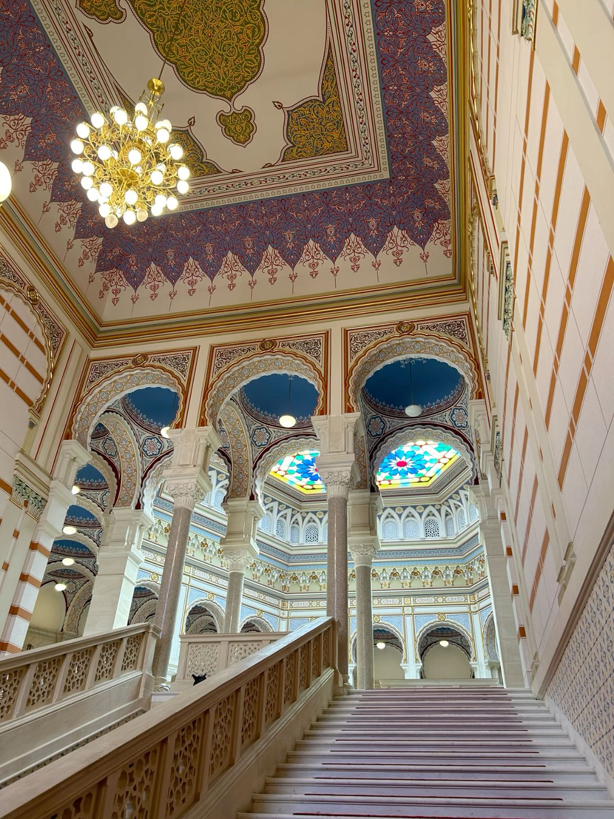 Painted arches and stained glass inside Sarajevo City Hall