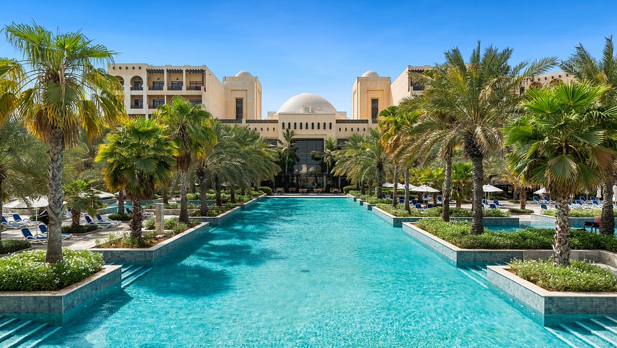 Resort pool and palm-lined gardens at Rixos Al Mairid Ras Al Khaimah