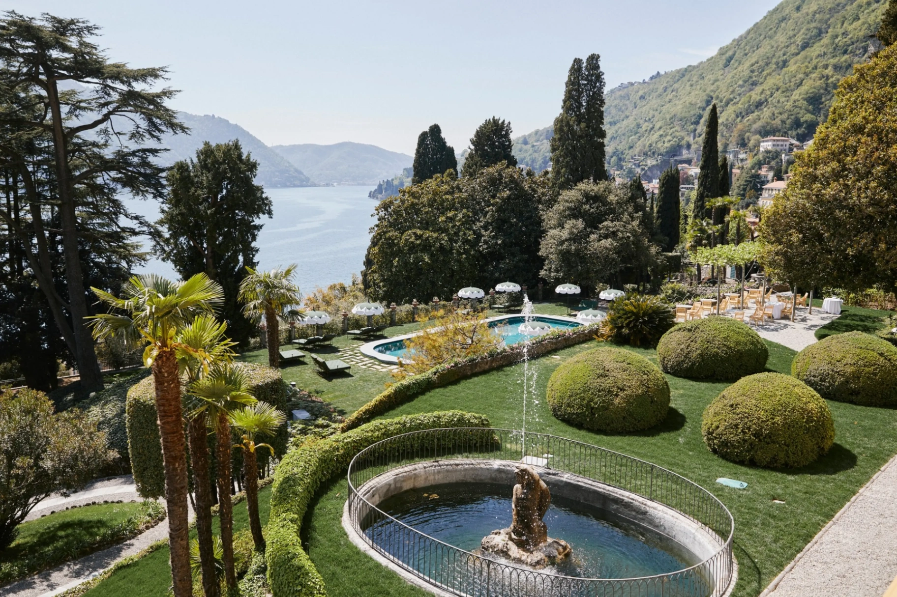 Passalacqua — terraced gardens with pool, fountain and clipped boxwood spheres overlooking Lake Como