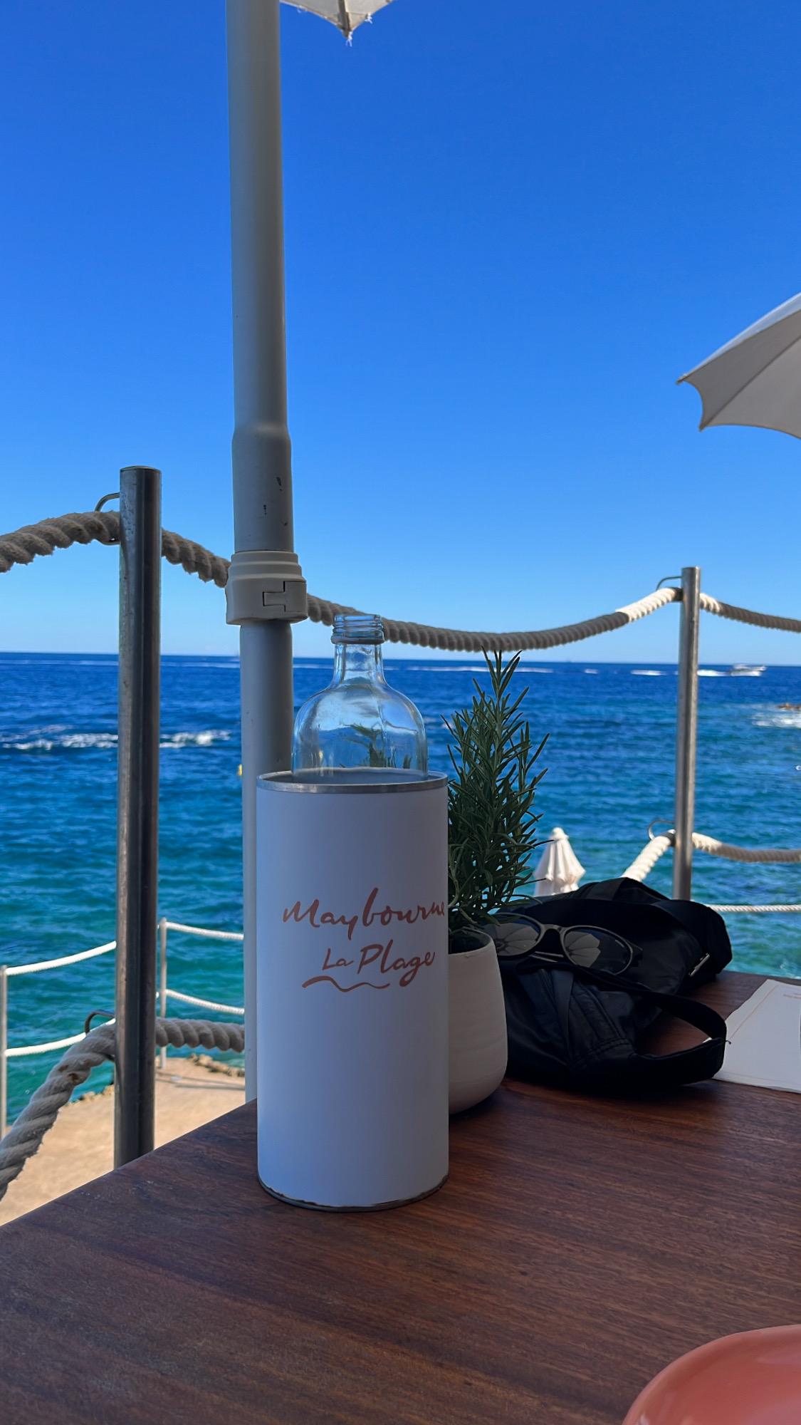 Din Tanovic — table at Maybourne La Plage on the Côte d'Azur, rosemary, candle and the blue sea