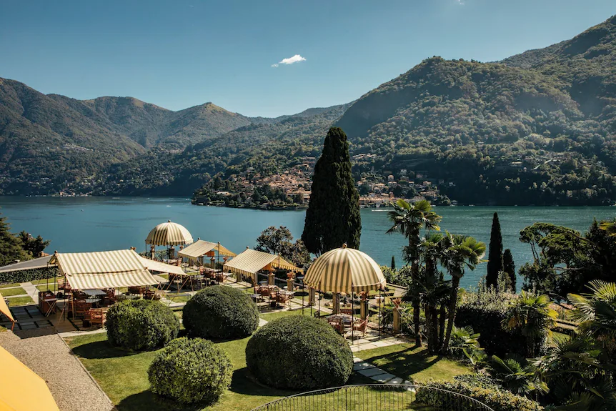 Passalacqua — striped garden pavilions and clipped topiary above Lake Como, framed by cypresses and the Moltrasio hillside