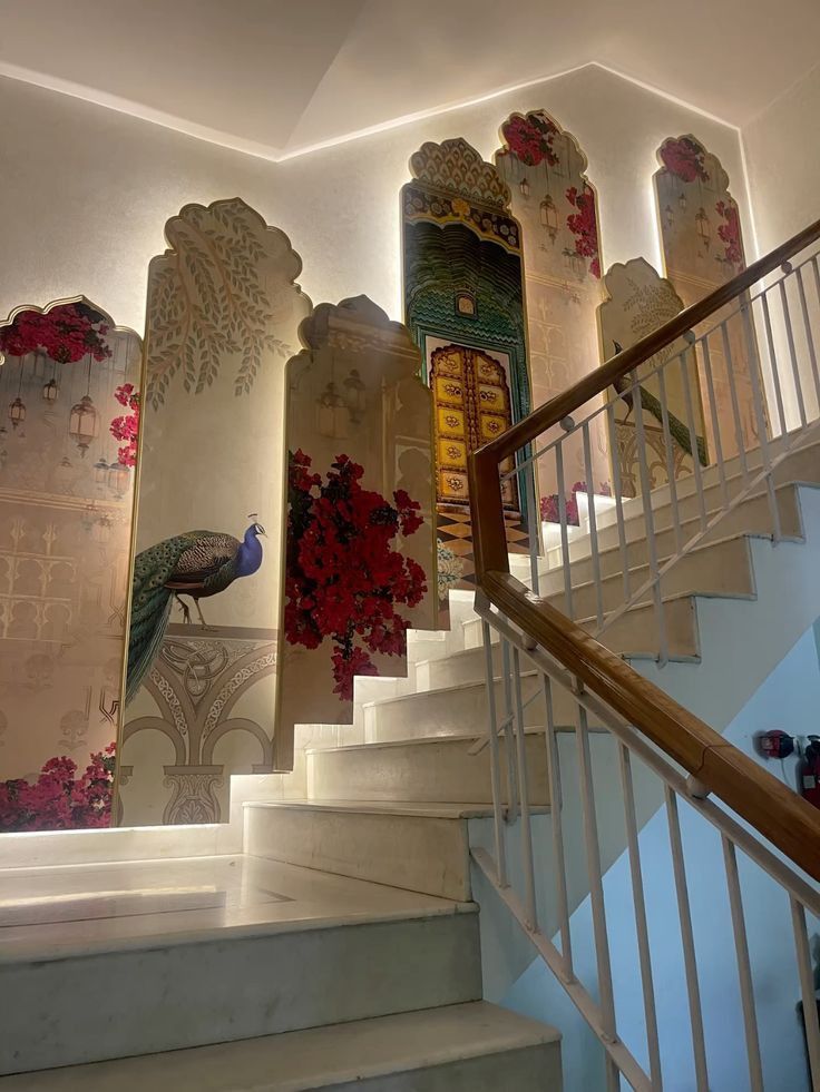 Peacock and bougainvillea murals lining a white marble staircase