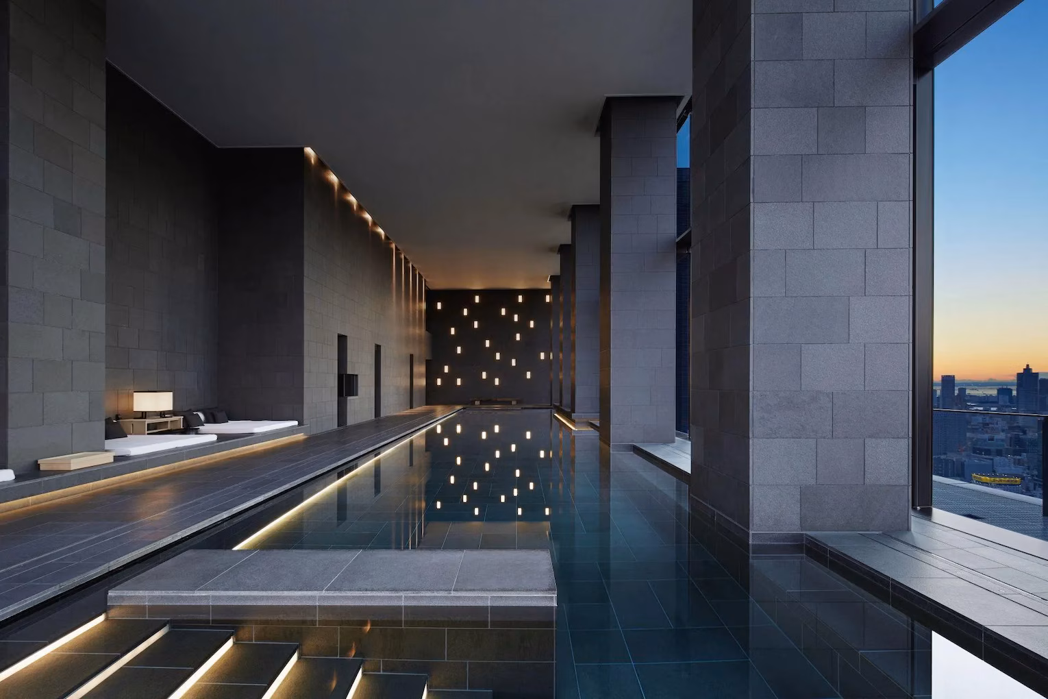 Indoor infinity pool overlooking the Tokyo skyline at dusk, Aman Tokyo